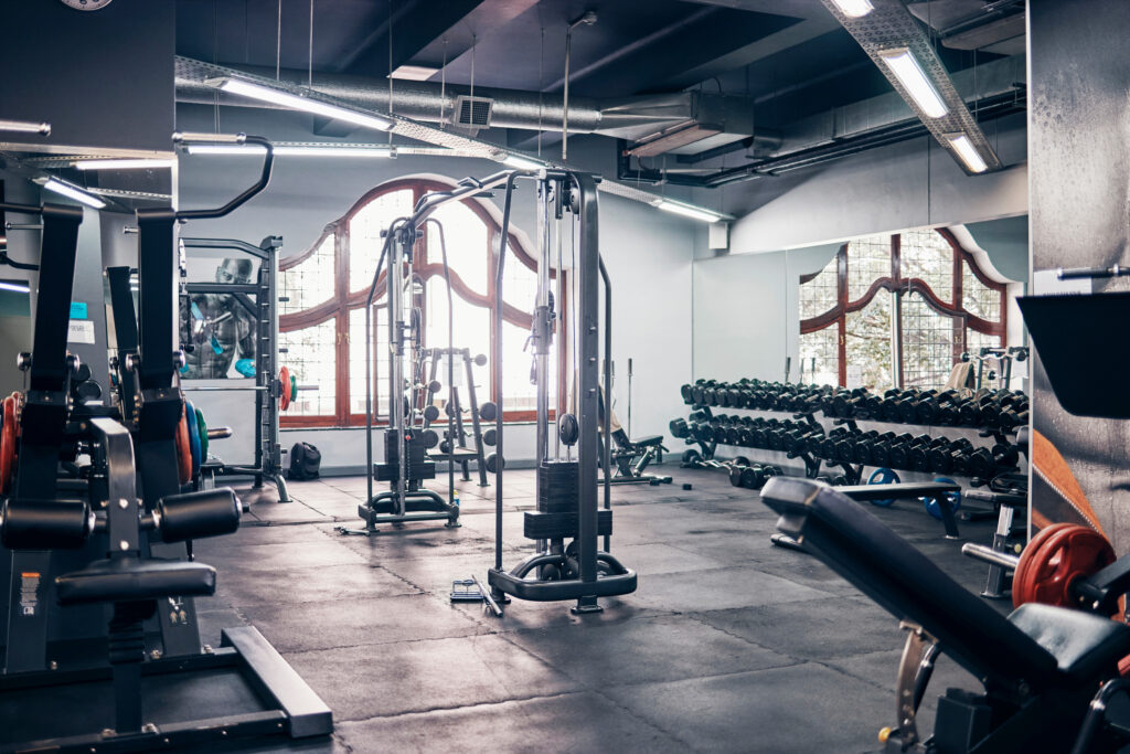 Image of a gym with weightlifting equipment.