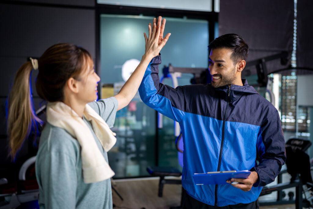 Gym owner and gym member celebrating