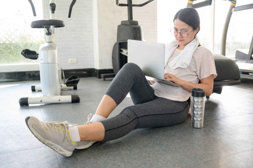 Fitness instructor working on her laptop