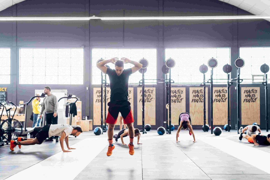 Athlete performing high-intensity workout in a branded gym space focused on energy and motivation.