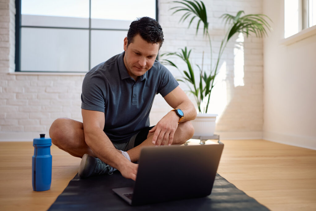 Personal trainer working on laptop
